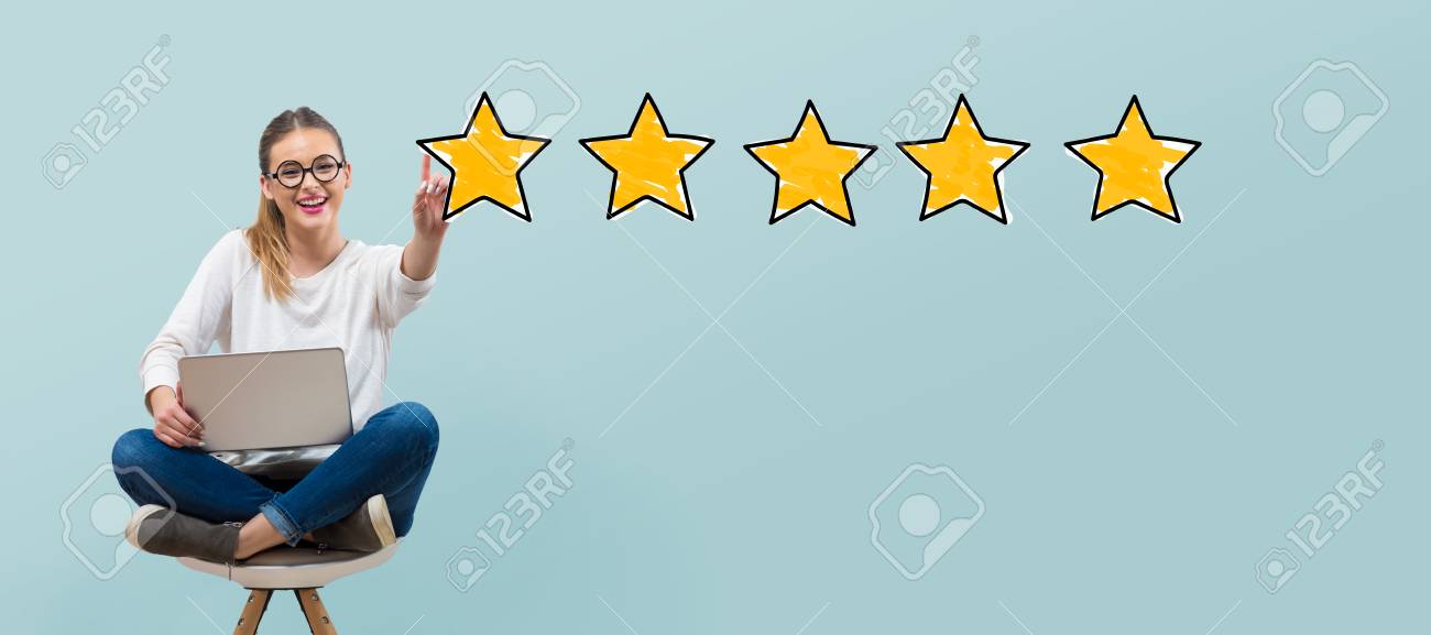 Five star rating with young woman using her laptop - 121028287 Five star rating with young woman using her laptop - 121028287