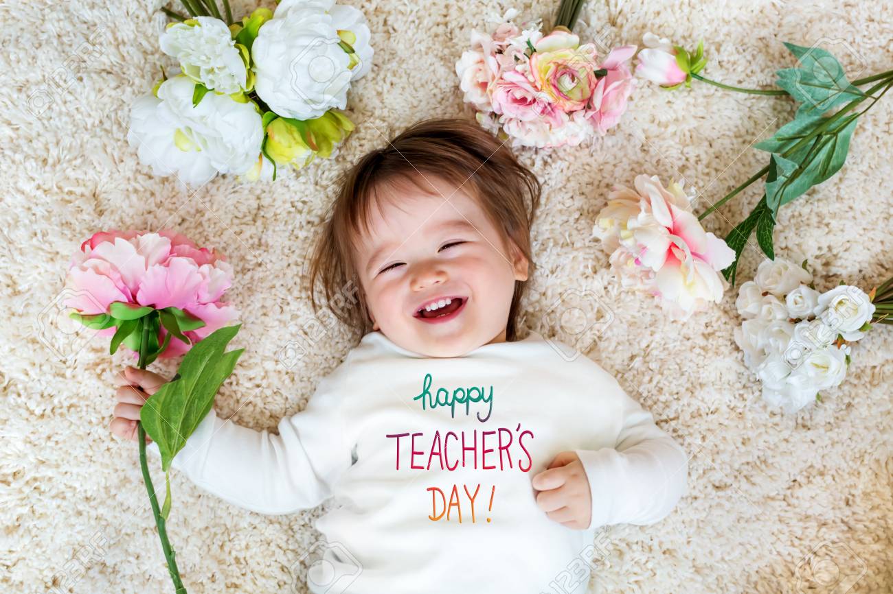 Teachers Day message with happy toddler boy with spring flowers - 121252934 Teachers Day message with happy toddler boy with spring flowers - 121252934