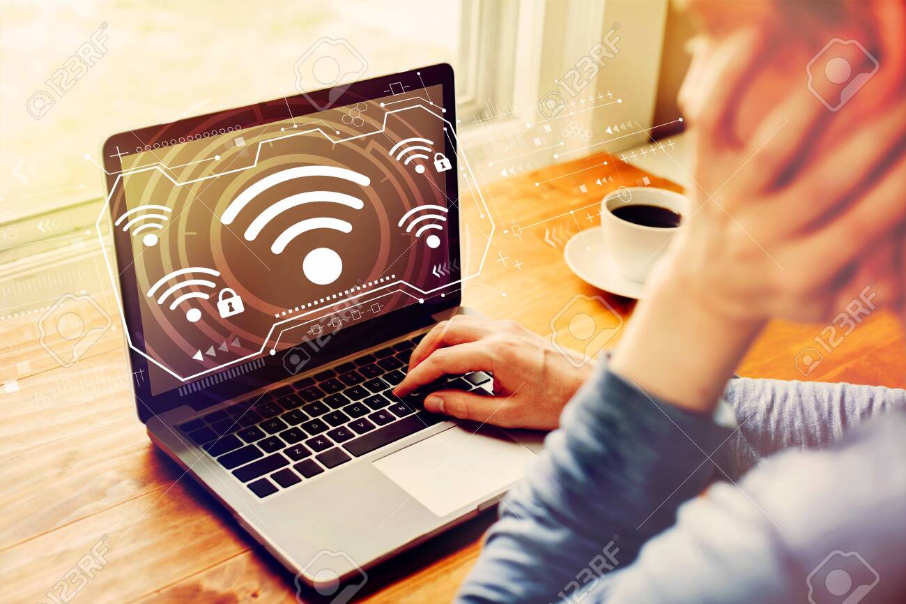 Wifi with man using a laptop computer - 124669017 Wifi with man using a laptop computer - 124669017