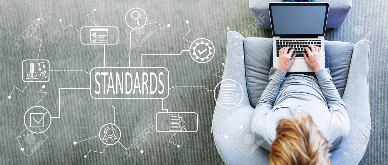 Standard quality control approval with man using a laptop in a modern gray chair - 126173600 Standard quality control approval with man using a laptop in a modern gray chair - 126173600
