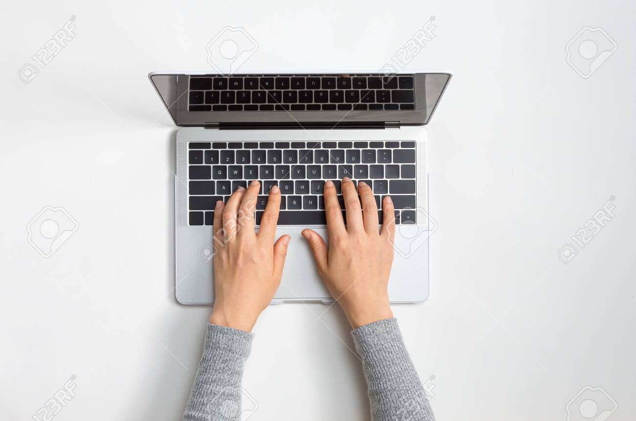 Person using a laptop computer at a work desk - 133804545 Person using a laptop computer at a work desk - 133804545