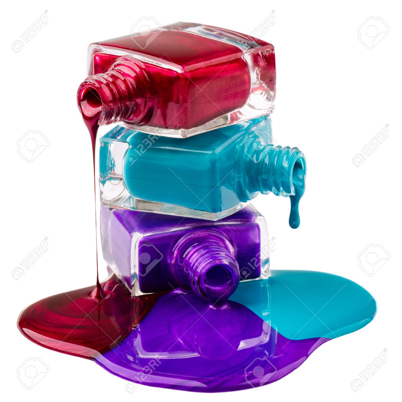 bottles with spilled nail polish over white background stock photo