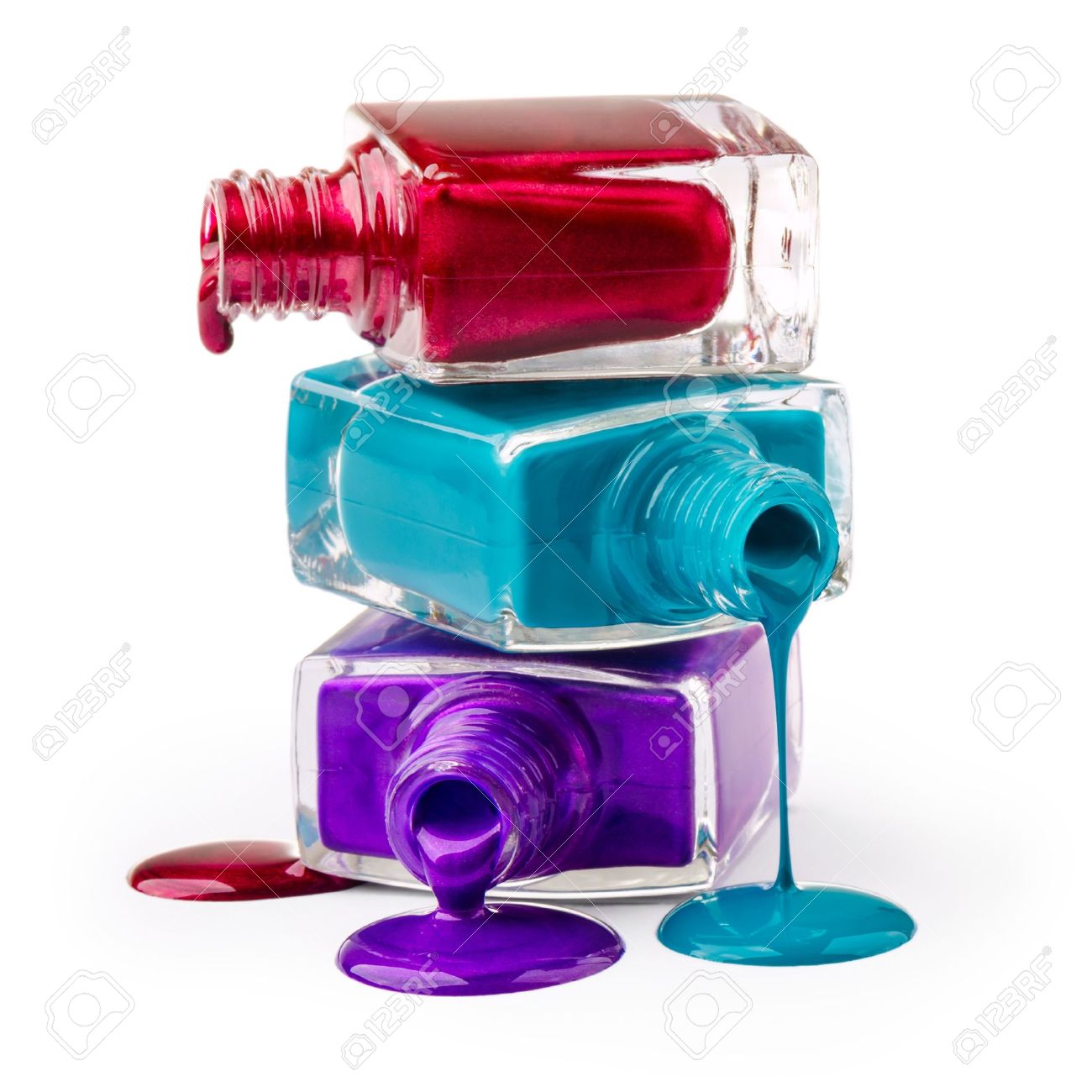 bottles with spilled nail polish over white background stock photo