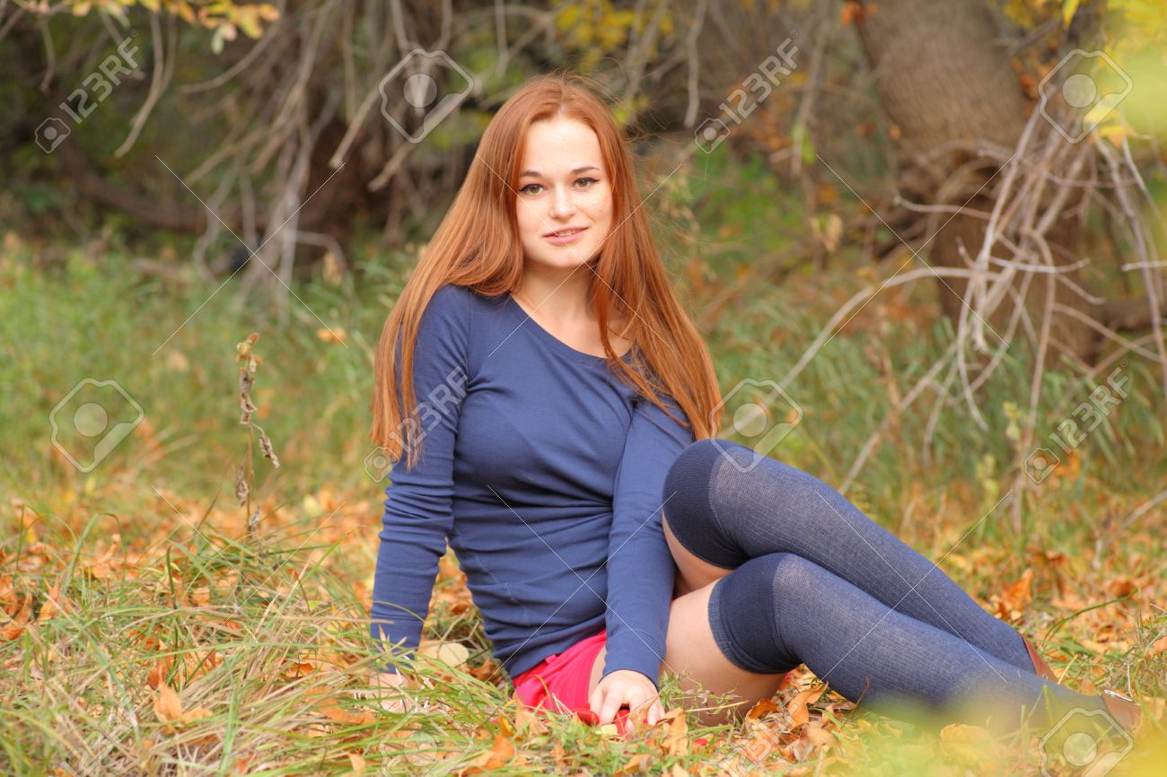 15690303-romantic-redhead-girl-sitting-i