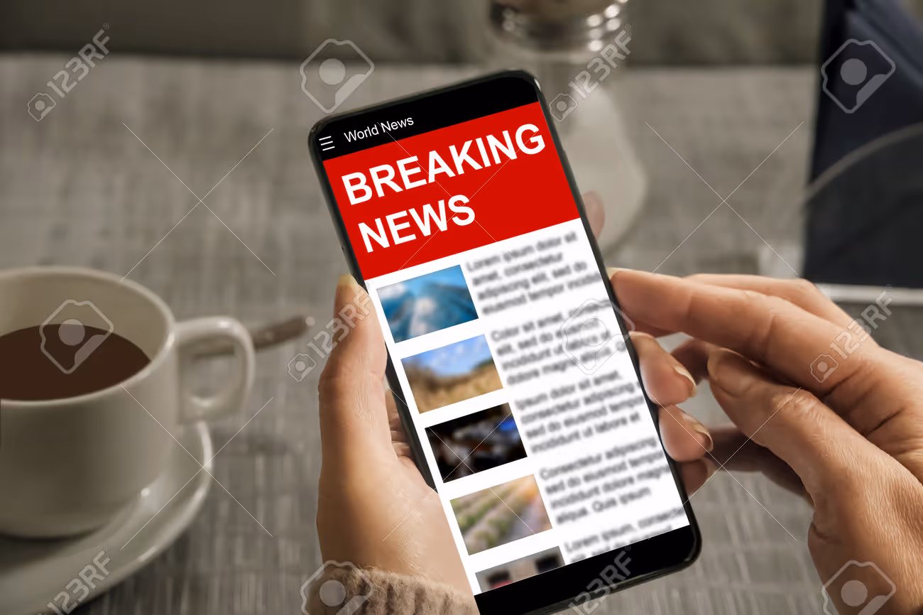 A woman reads a news site on a smartphone. Quick access to breaking news - 198263097 A woman reads a news site on a smartphone. Quick access to breaking news - 198263097
