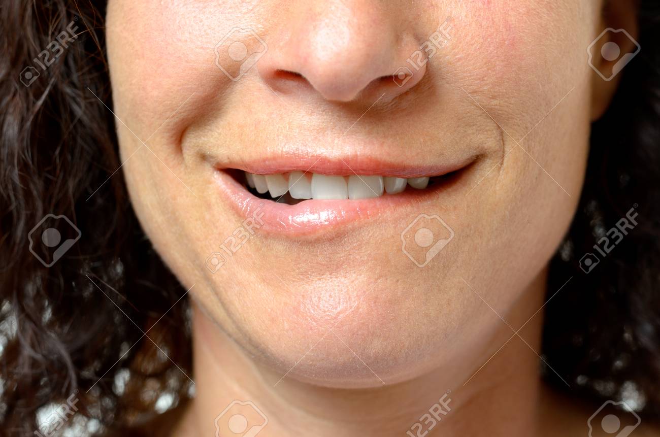 Woman biting her lip in seductive anticipation – intense pleasure building