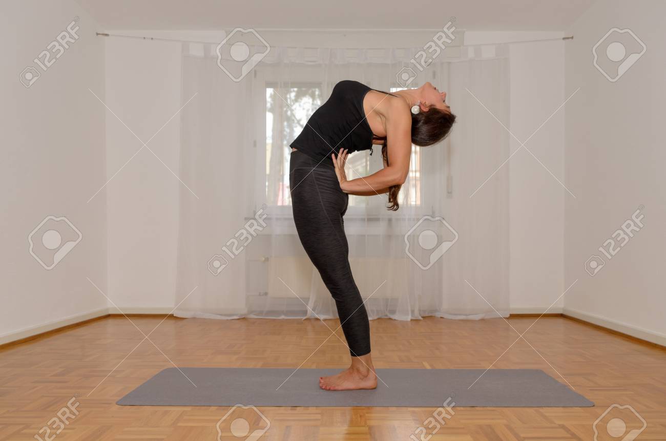 Supple Sporty Woman Working Out At Home On A Mat On The Floor