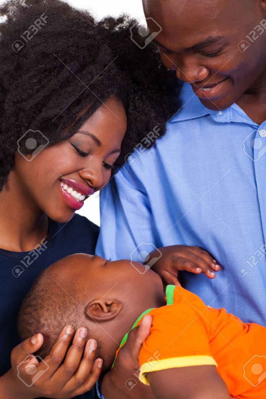 Cute Young Black Couple Looking At Their Sleeping Baby Son Stock