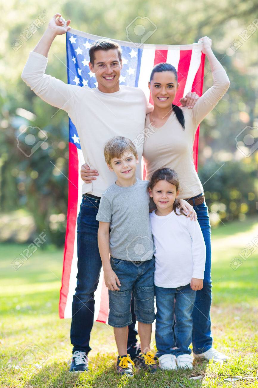 American family of four with usa flag outdoors stock photo 28965213