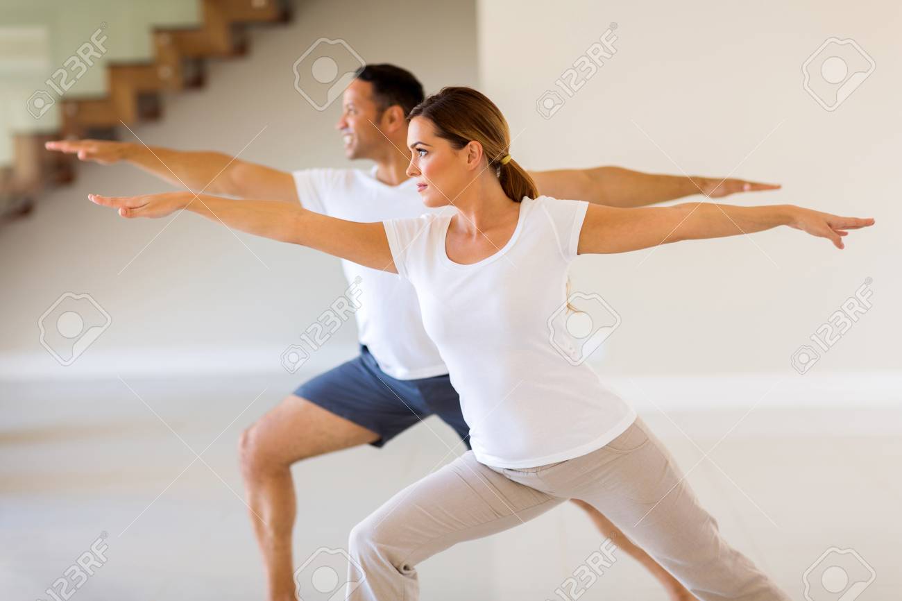 フィットのカップルが室内で運動の側面図 の写真素材 画像素材 Image