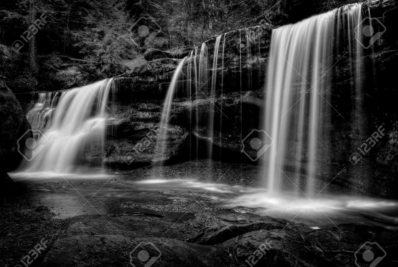 a hidden waterfall in hocking hills ohio in black and white stock