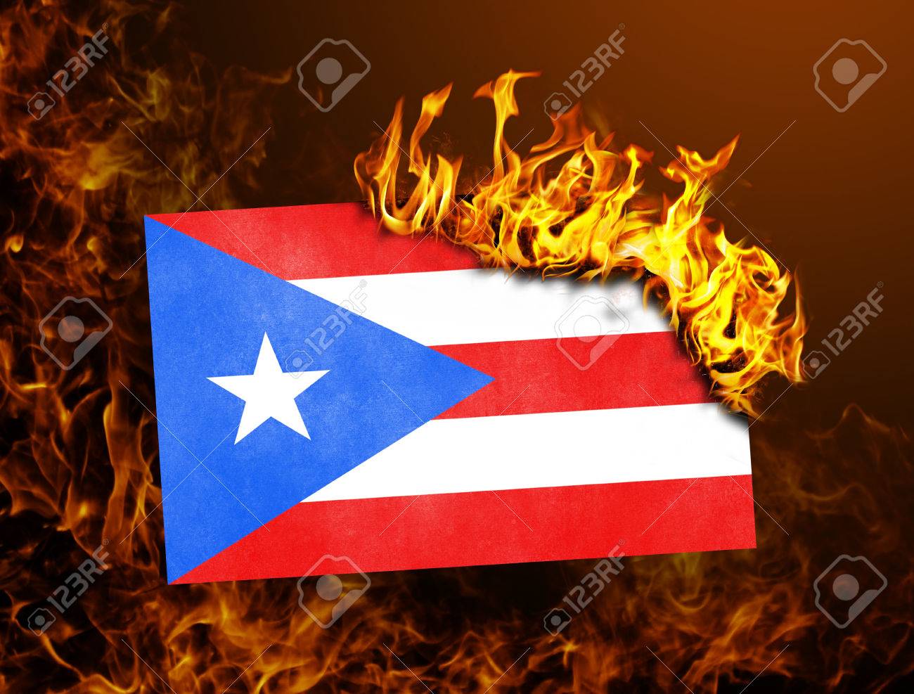 Flag Burning Concept Of War Or Crisis Puerto Rico Stock Photo