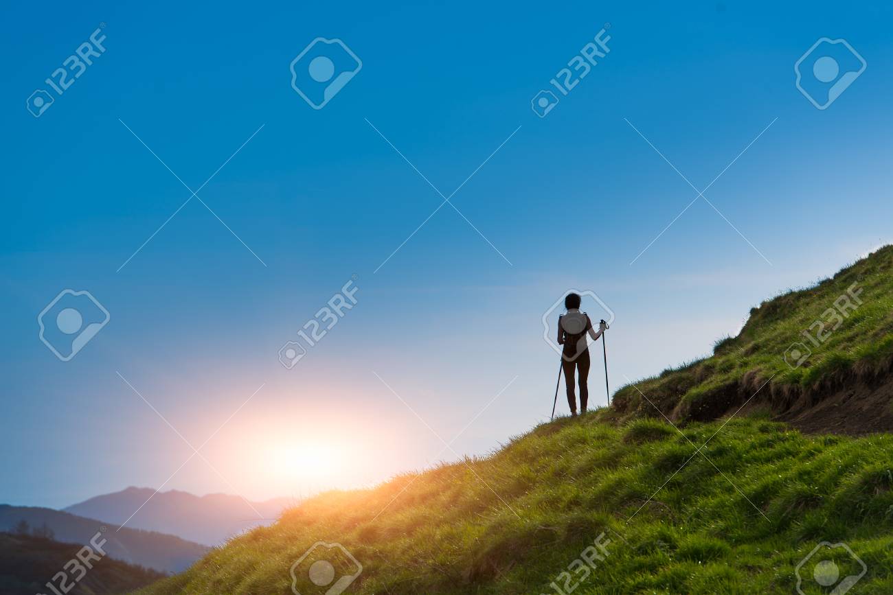 Silhouette of girl that makes trekking at sunset - 40015543 Silhouette of girl that makes trekking at sunset - 40015543