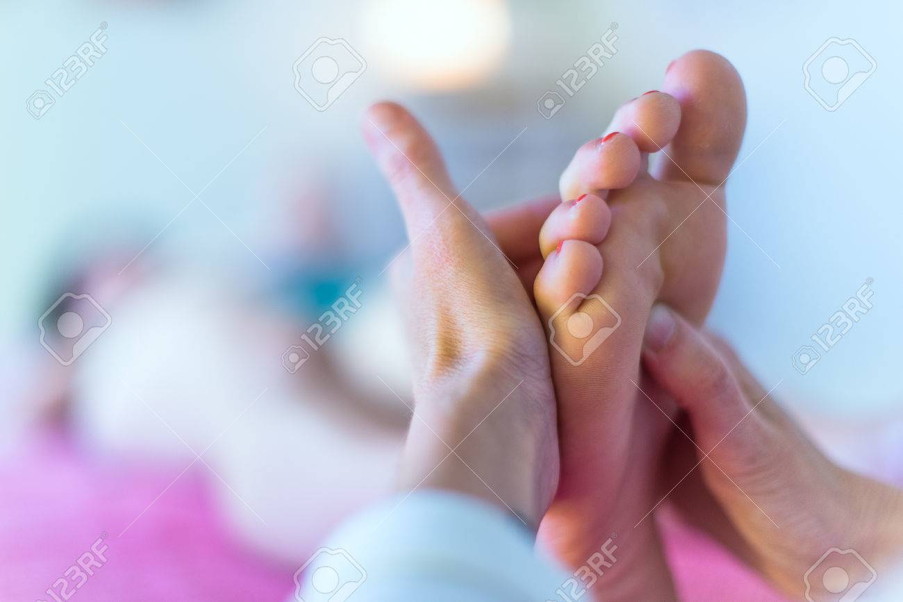 Close up of therapist's hands massaging female foot - 48956490 Close up of therapist's hands massaging female foot - 48956490