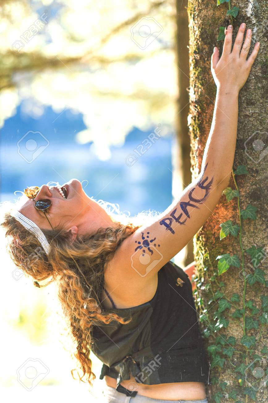 pretty free hippie girl laughing peace body painting outdoor