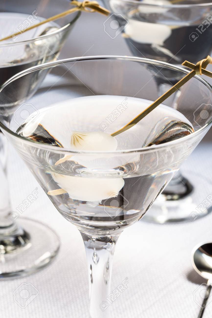 neat martini with pearl onion garnish stock photo picture and