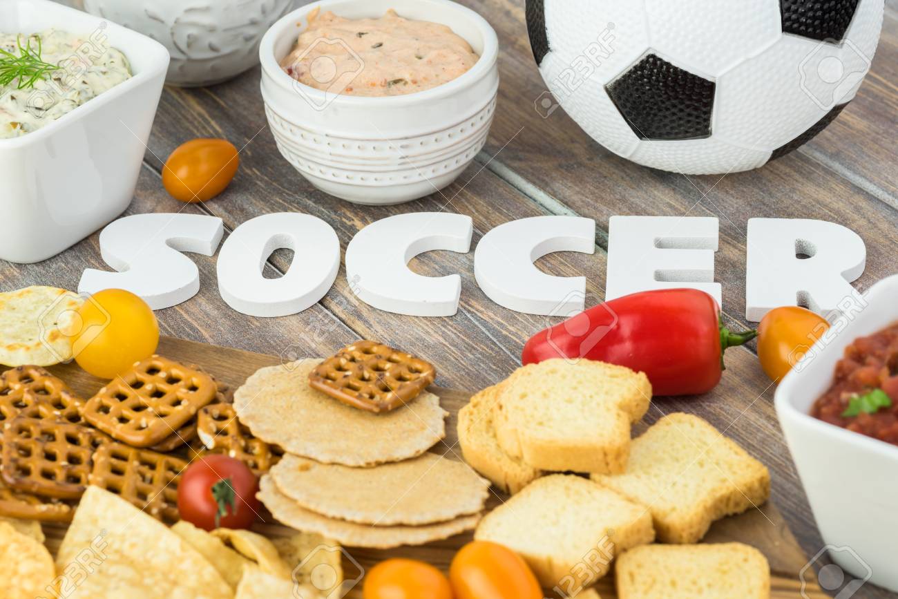 close up of party table with variety of snacks and dips for soccer