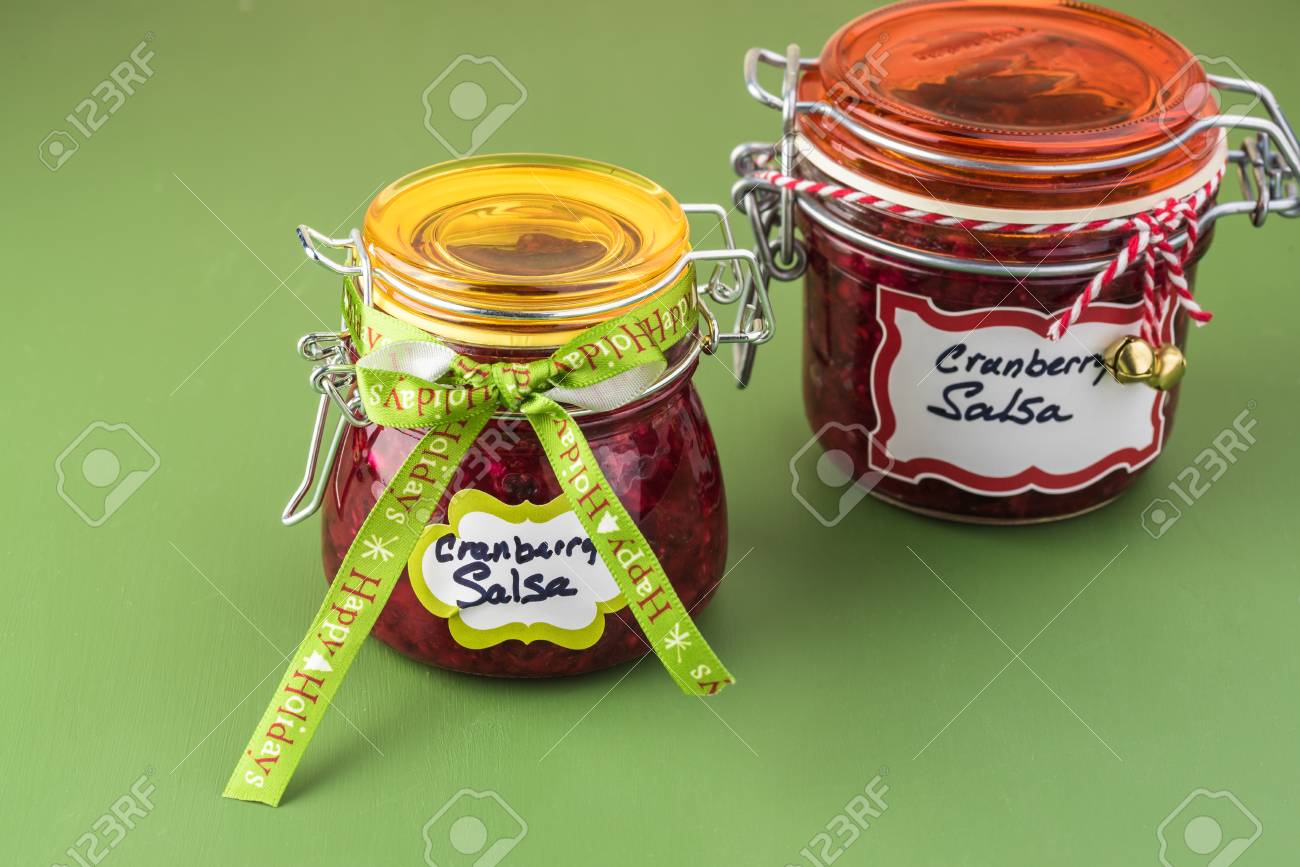 close up of jars with fresh homemade cranberry salsa decorated