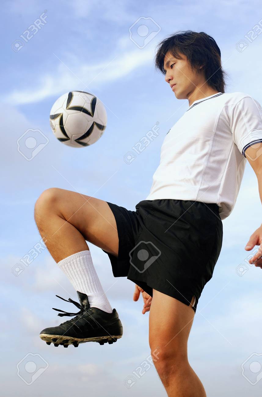 man bouncing soccer ball