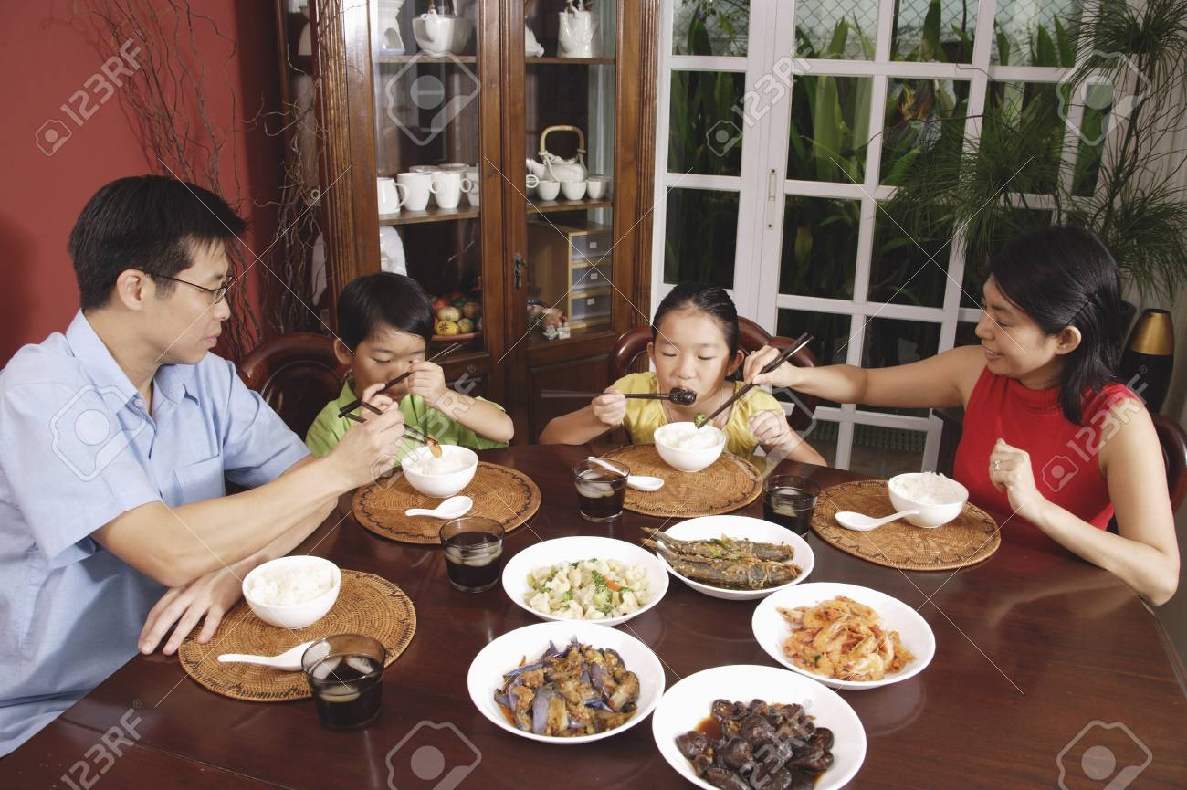 Family of four having dinner at home - 69312166 Family of four having dinner at home - 69312166