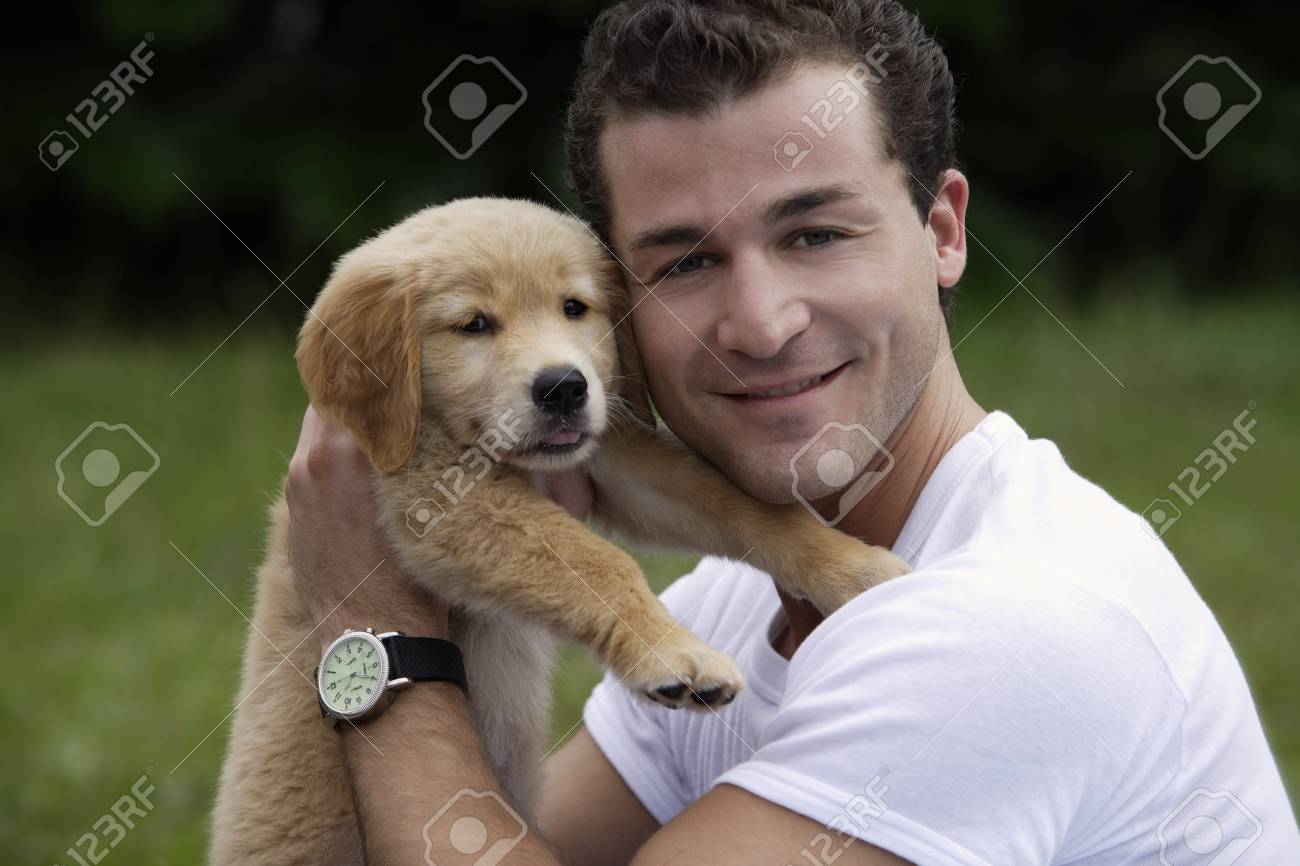 Man Holding Puppy Stock Photo Picture And Royalty Free Image Image 69306547