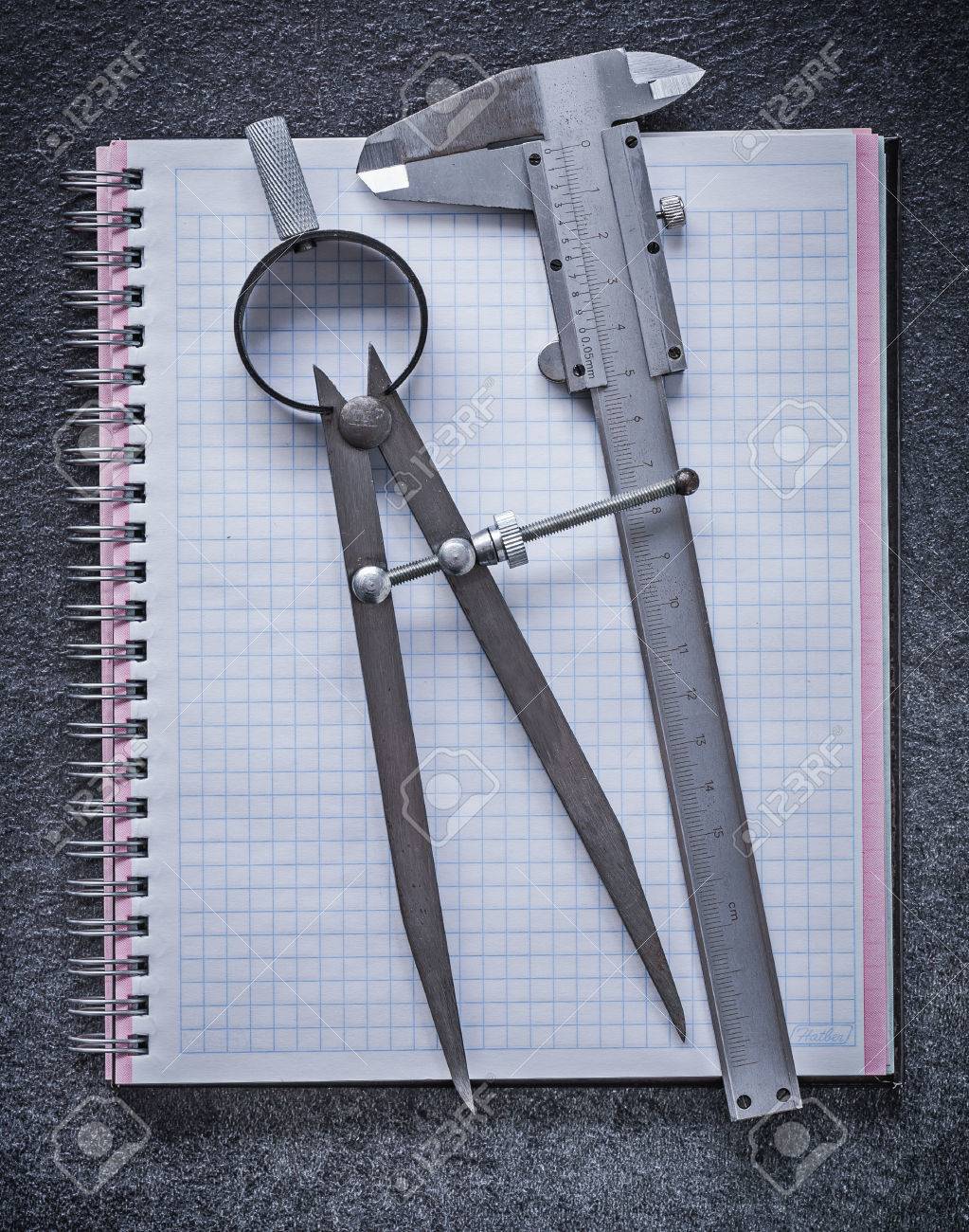 drawing compass slide caliper notebook on black background slide compass