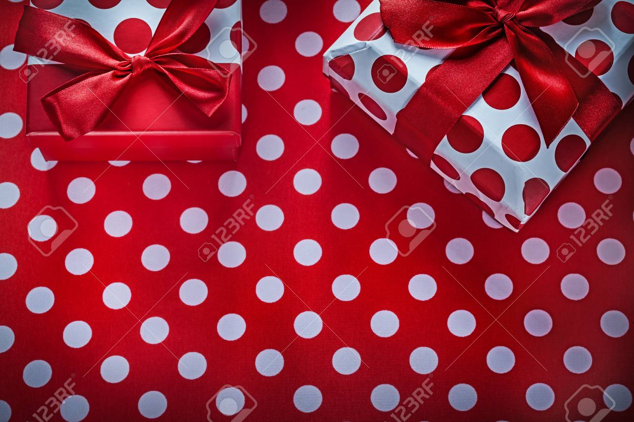 present boxes on polka dot red print background holidays concept