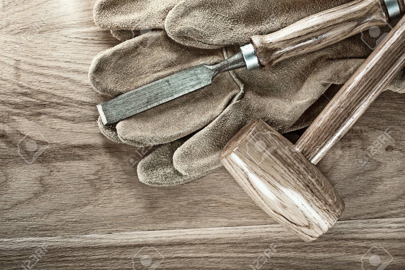Lump hammer flat chisel protective gloves on wood board. - 105587307 Lump hammer flat chisel protective gloves on wood board. - 105587307