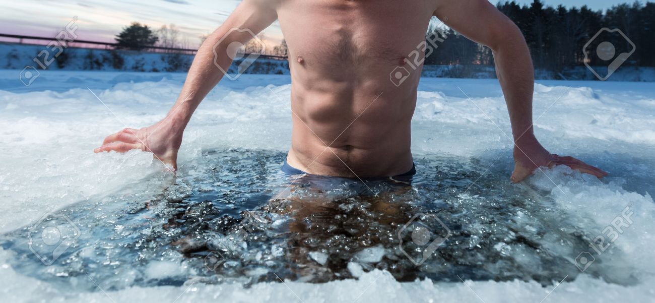 Young man bathing in the ice hole. Focus on the ice in a water only - 50602570 Young man bathing in the ice hole. Focus on the ice in a water only - 50602570