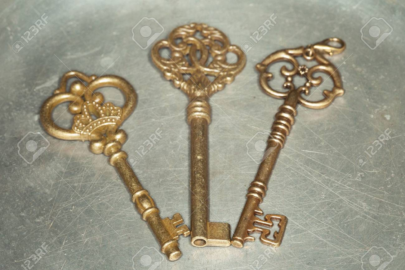 Three Antique Golden Door Keys On Iron Plate Stock Photo, Picture Stock Photo - Three antique golden door keys on iron plate - Three Antique Golden Door Keys On Iron Plate Stock Photo, Picture