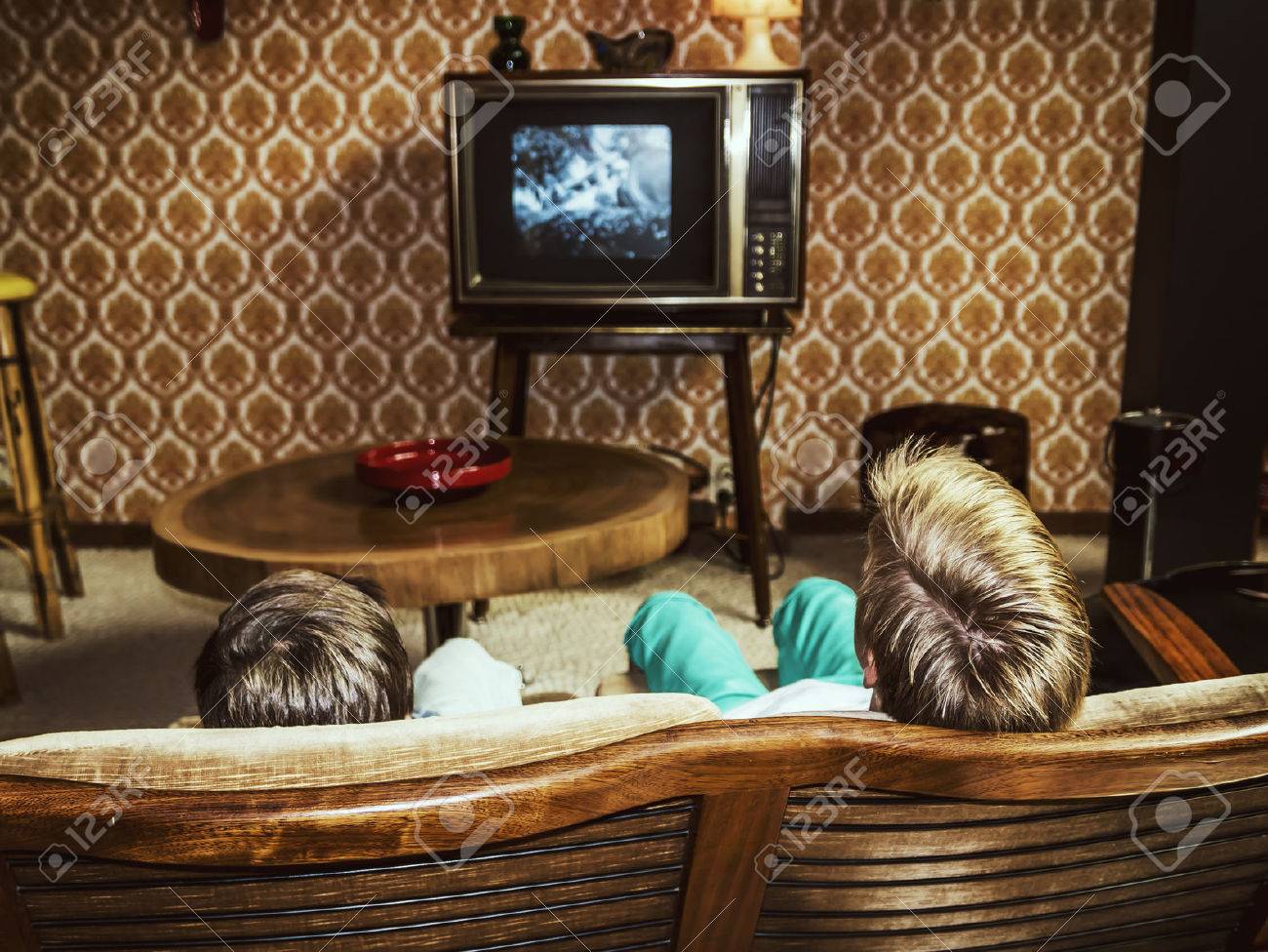 two boys watching television at home in 50's style, shot from behind - 53551237 two boys watching television at home in 50's style, shot from behind - 53551237