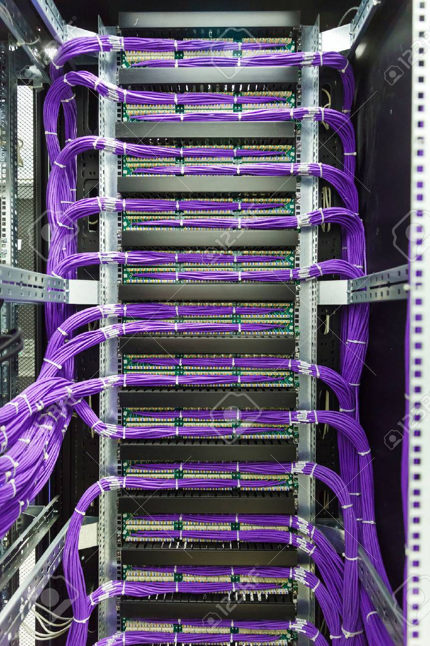 large group of lilac utp internet cables in rack data center stock data rack