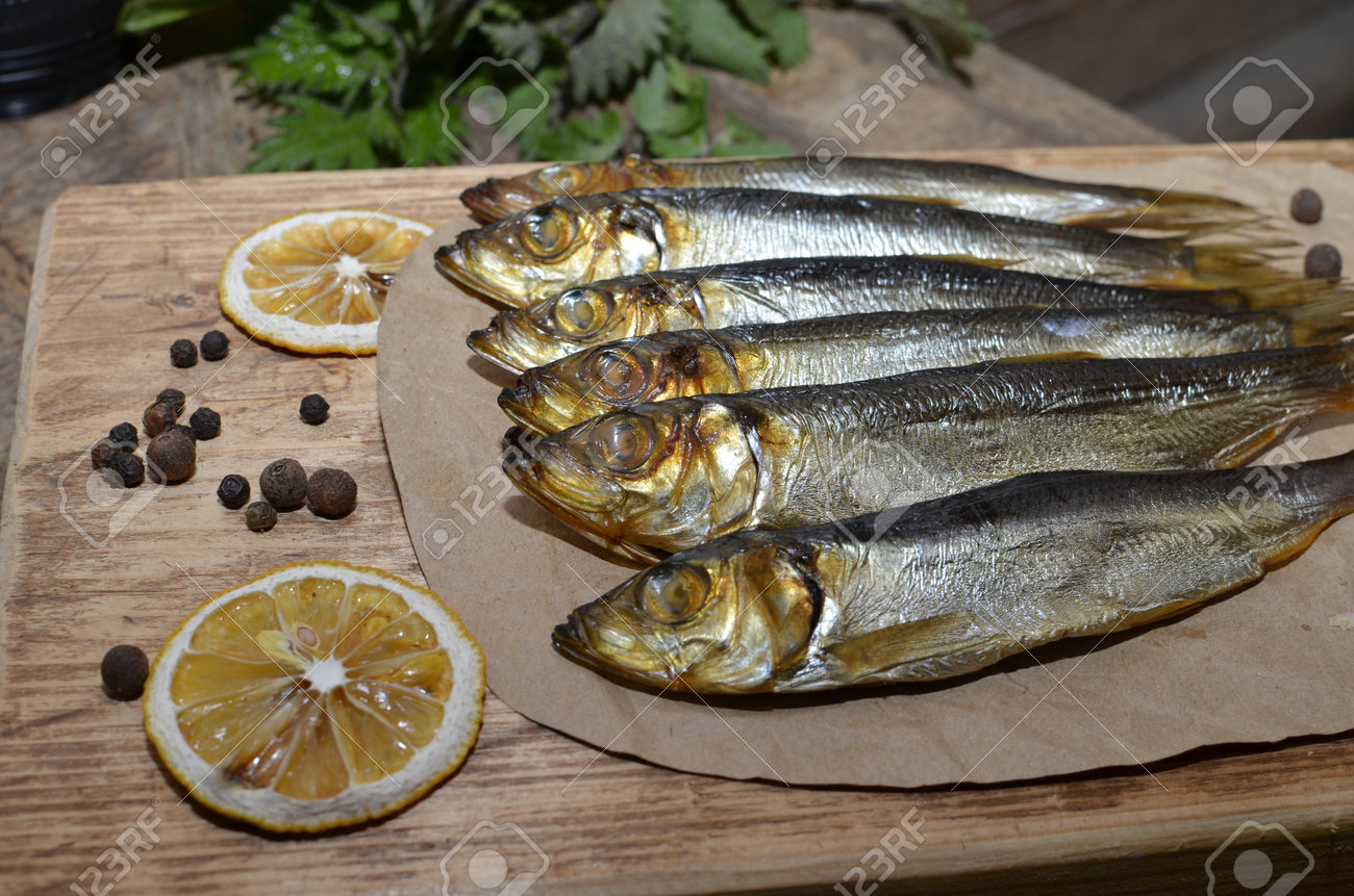 Delicious smoked salmon herring beautifully garnished on a rustic wooden table - 168508543 Delicious smoked salmon herring beautifully garnished on a rustic wooden table - 168508543