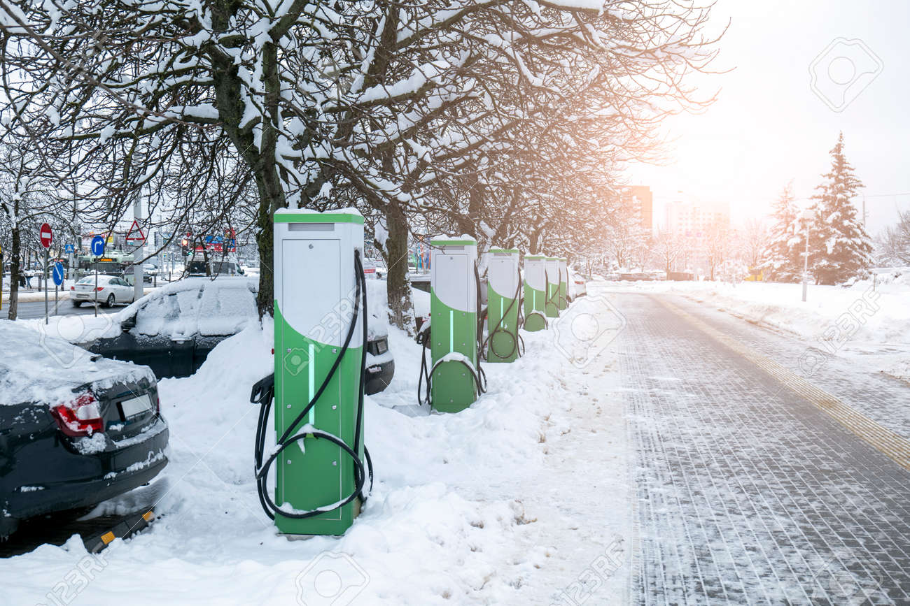 refueling for electric vehicles in winter. ecological chargers for cars with electricity - 170497588 refueling for electric vehicles in winter. ecological chargers for cars with electricity - 170497588