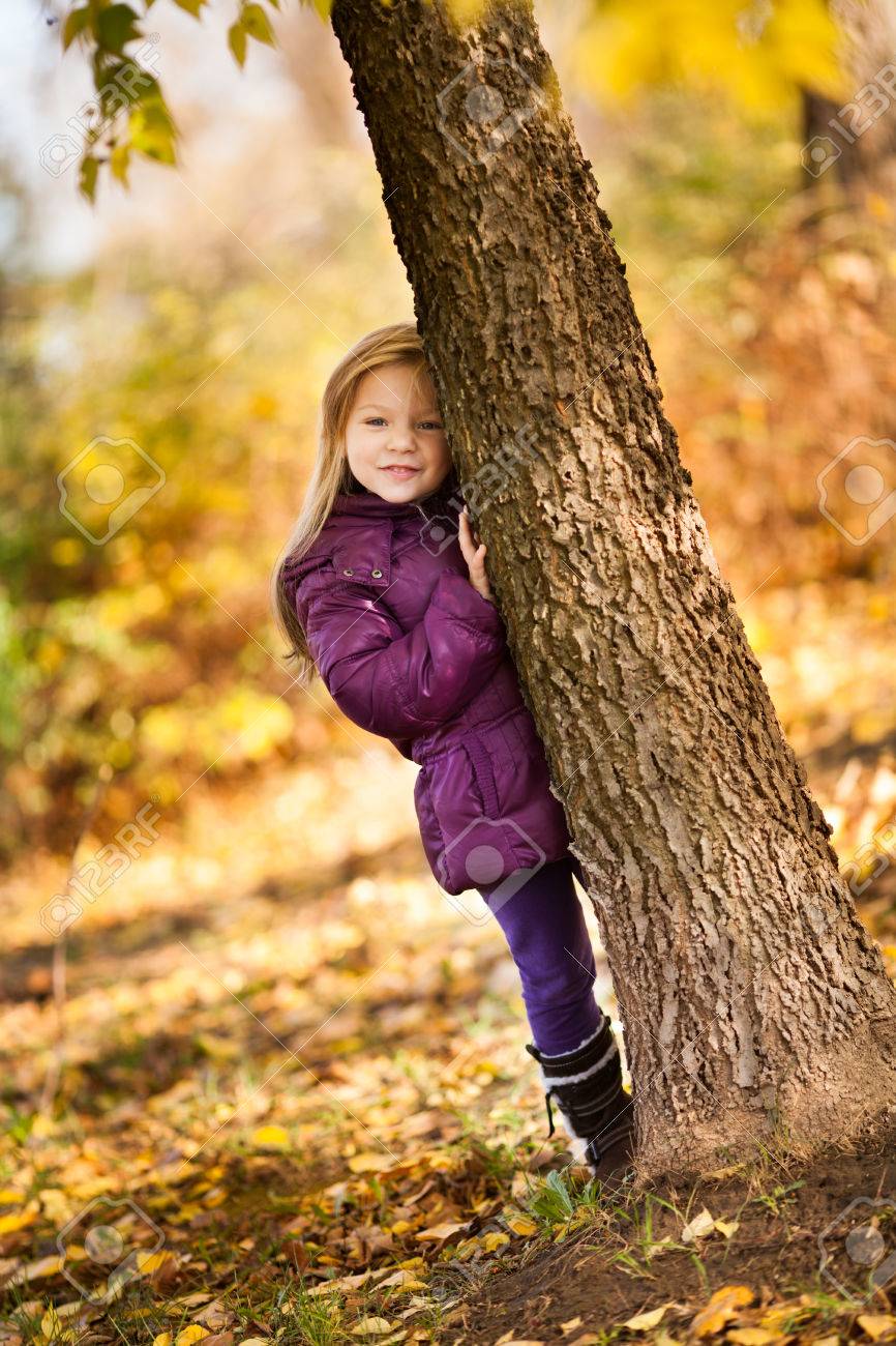 Cute Little Girl In The Park Hiding Behind The Tree Stock Photo Picture And Royalty Free Image Image 31256564
