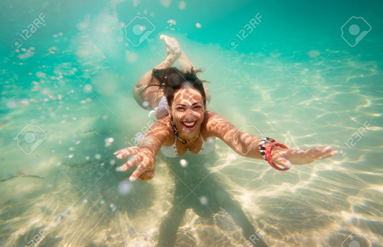 Beautiful Young Woman Diving Underwater In The Sea. Stock Photo, Picture  and Royalty Free Image. Image 76957180., image size:1300x839