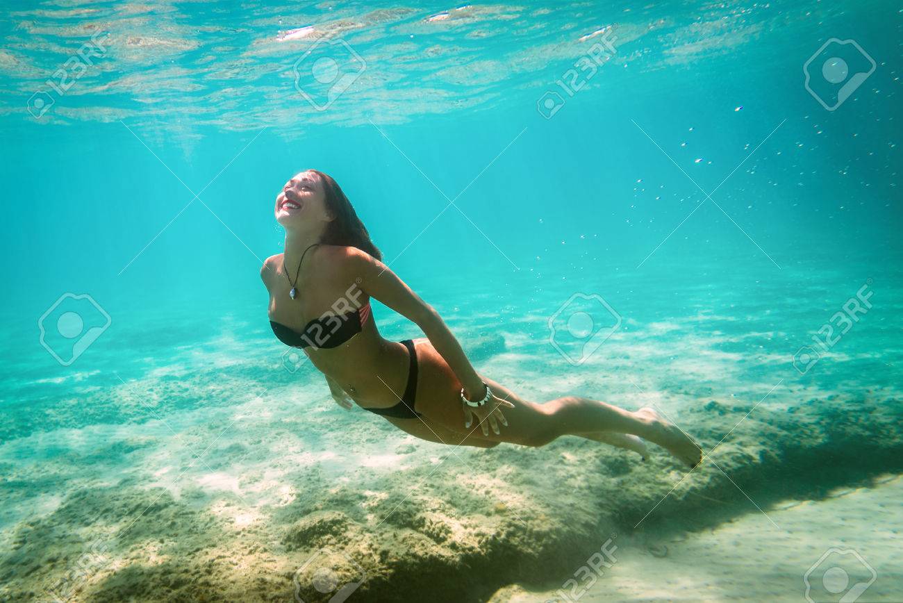Beautiful Young Smiling Woman Swimming Underwater In The Sea. Stock Photo,  Picture and Royalty Free Image. Image 80306643., image size:1300x868