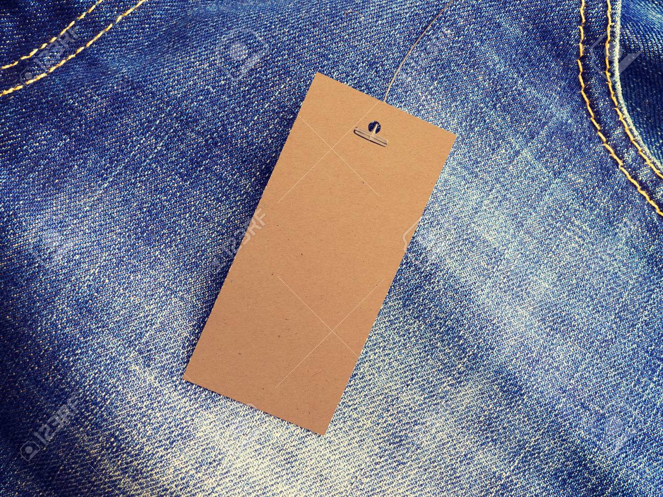 label price tag mockup on blue jeans from recycled paper stock