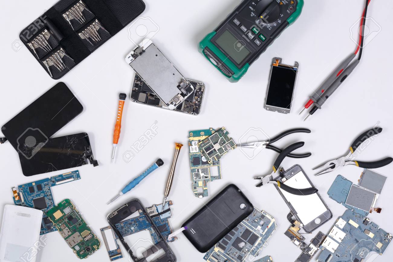 Mobile phone repair flat lay background, top view of workplace at service center. Smartphone