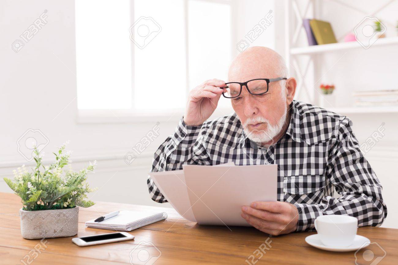 https://previews.123rf.com/images/milkos/milkos1707/milkos170703763/83044164-shocked-senior-man-looking-at-bills-in-disbelief-holding-his-glasses-on-forehead-copy-space.jpg