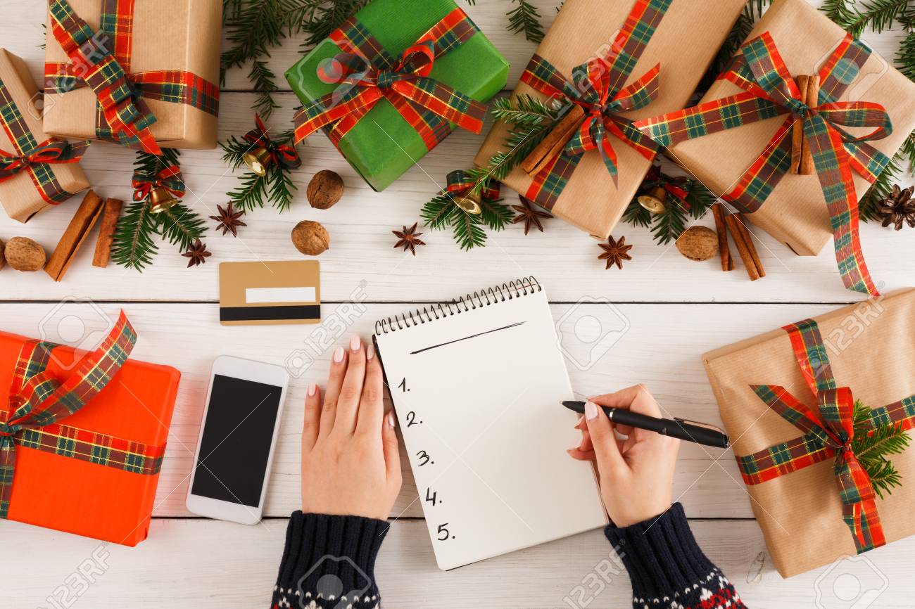 christmas wish list and online shopping background female hands