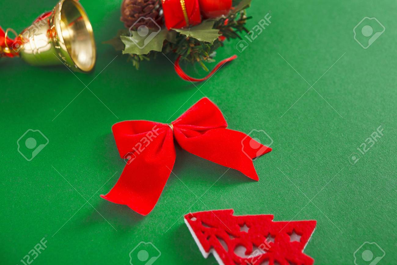 Download Christmas Decorations Red Bow Jingle Bells On Green Background Stock Photo Picture And Royalty Free Image Image 88923302 PSD Mockup Templates