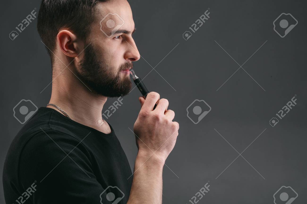 Man With Vape At Black Studio Background Closeup Young Guy Smoking Stock Photo Picture And Royalty Free Image Image 91035047