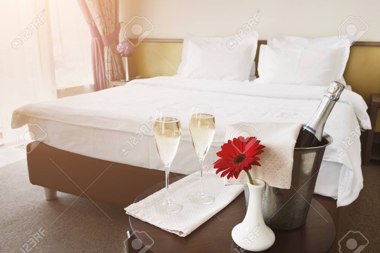 Two Glasses Of And Champagne In Ice Bucket In Hotel Romance