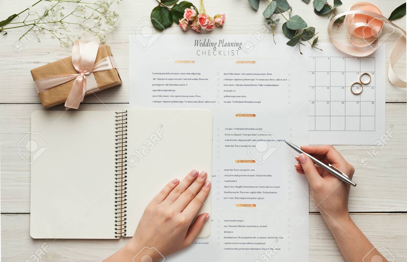 wedding background with checklist and calendar female hands wedding calendar checklist