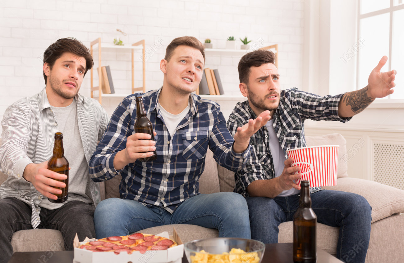Upset Friends Watching Football Match, Drinking Beer At Home Stock Photo,  Picture And Royalty Free Image. Image 120396962.
