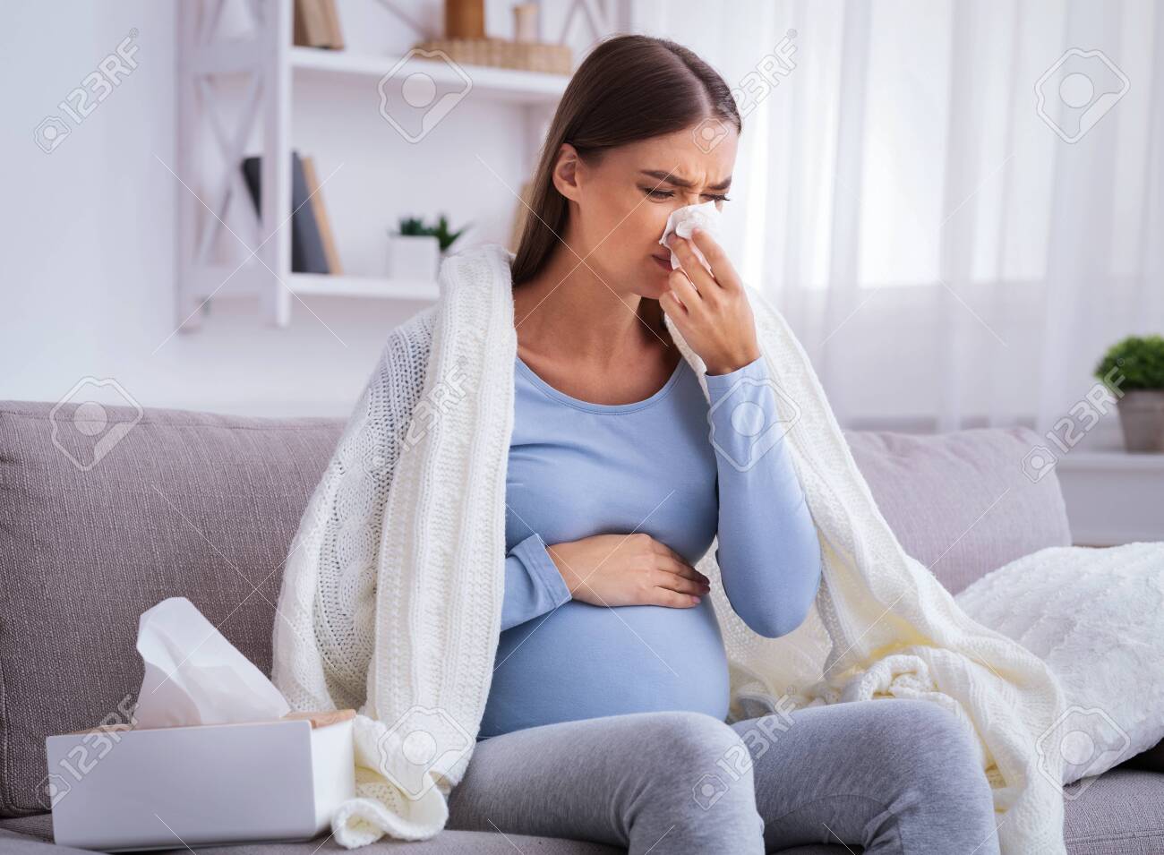 Sick Pregnant Woman Feeling Unwell Blowing Nose In Tissue Sitting Stock Photo Picture And Royalty Free Image Image 139279682