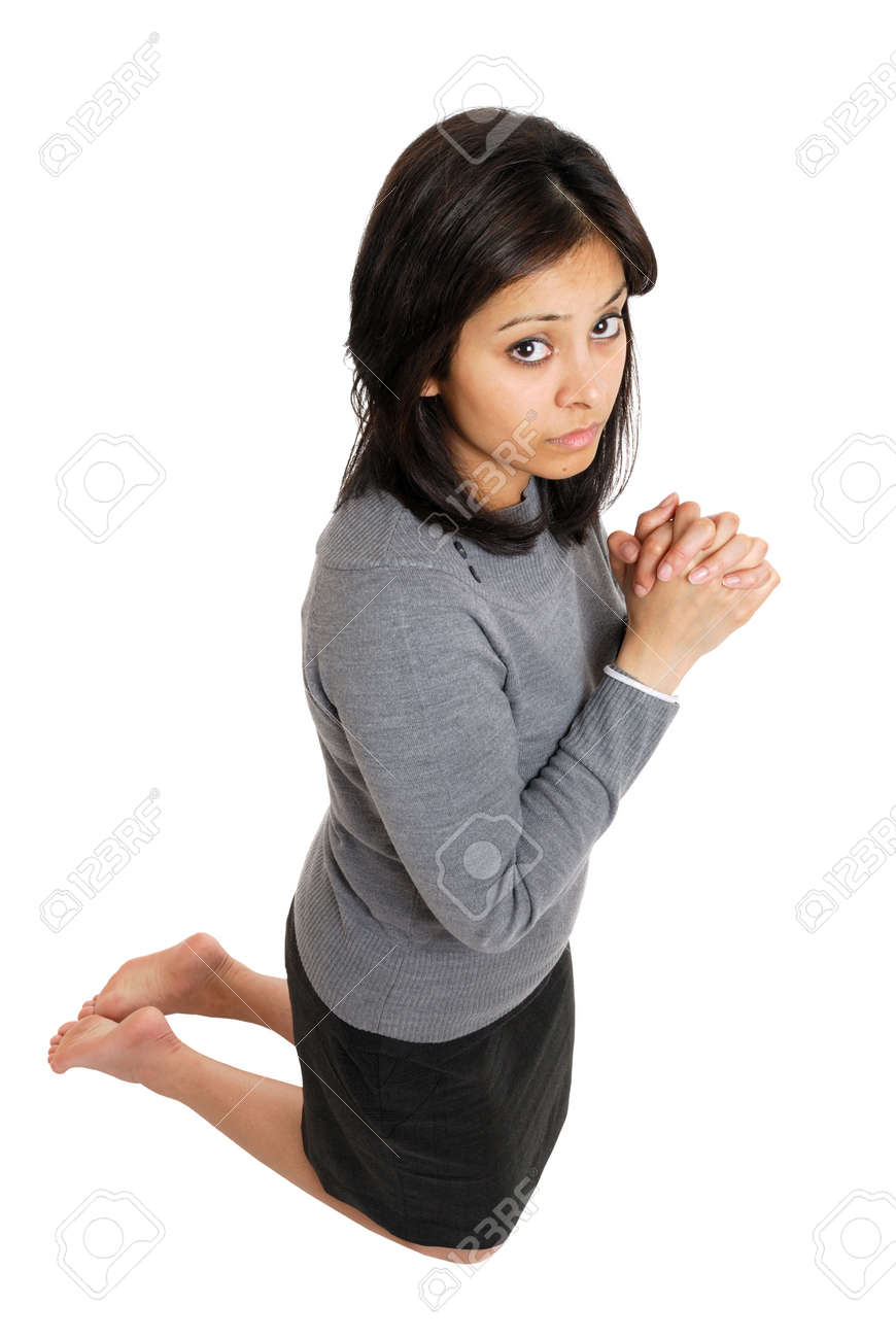 this is an image of woman kneeling doing prayer gesture stock photo