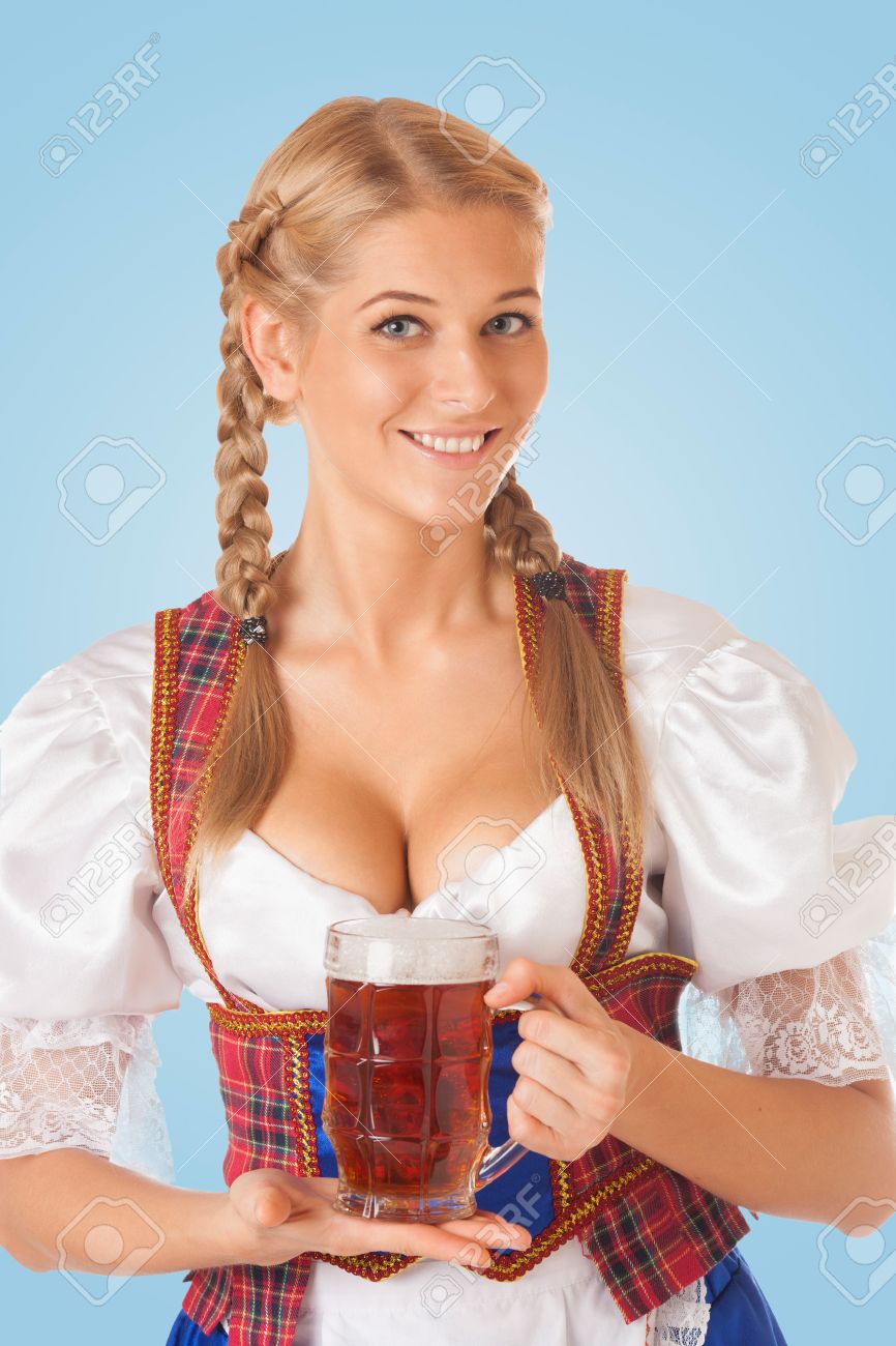 Young Sexy Oktoberfest Woman Wearing A Traditional Bavarian Dress Dirndl  Serving Beer Mugs Stock Photo, Picture and Royalty Free Image. Image  30174800.