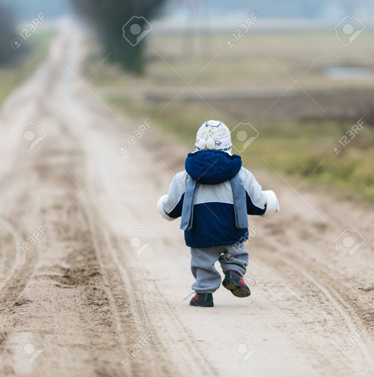 Little child walking self by rural sandy road - 37471783 Little child walking self by rural sandy road - 37471783